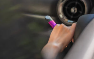 hand holding purple relx vape device